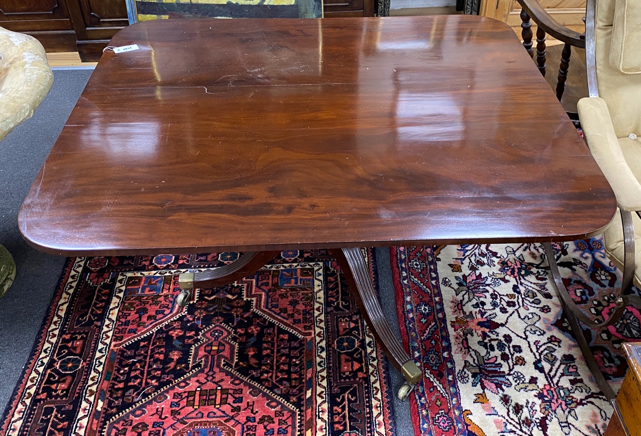 A Regency rectangular mahogany snap top breakfast table on brass casters, width 128cm depth 109cm height 70cm